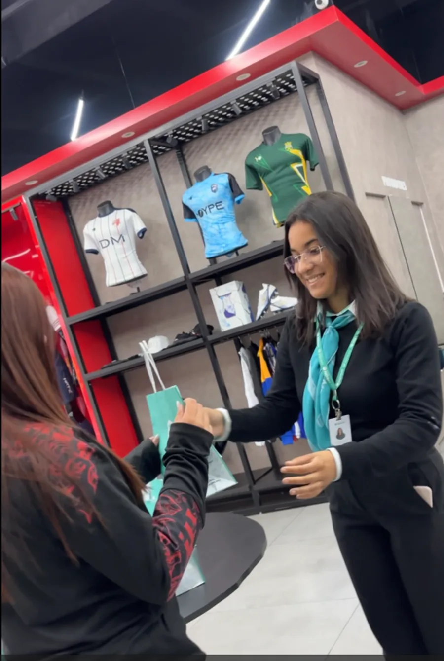 Entrega de uma sacola das Óticas Prevent durante a ação na Moype Sports